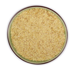 Wheat germ pile in porcelain bowl isolated on white background, top view