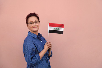Iraq flag. Woman holding Iraqi flag.