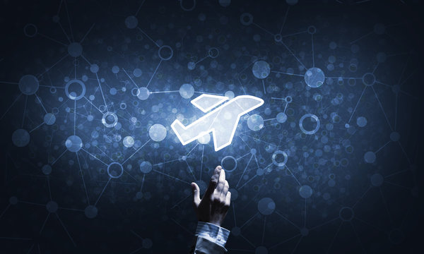 Airplane glowing icon touched with finger as online booking concept