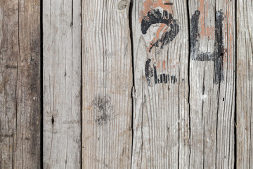 Rough wooden wall with black number 24