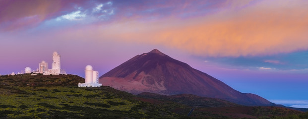 astronomical observatory against the background of a volcano at sunrise