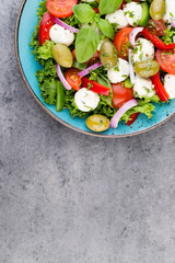 Vegetable salad with cheese mozzarella, tomatoes, basilikum and spice.