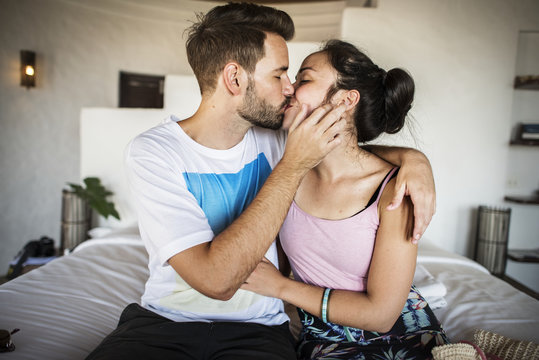 Young couple kissing on the bed