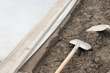 Preparing borders and pavement during road repairing on the street.