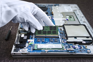 close up macro brush working cleaning the broken laptop. Disassembled modern ultrabook without...