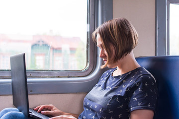 woman with a laptop on the train