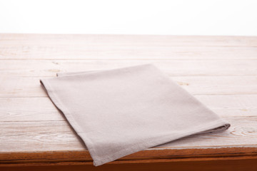 Empty wooden table with tablecloth. Napkin close up top view mock up. Kitchen rustic background.