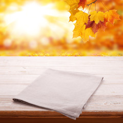 Naklejka na ściany i meble Empty wooden table with tablecloth. Napkin close up top view mock up. Autumn rustic background.