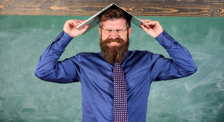 Hipster teacher aggressive with laptop as roof goes mad about teaching. Teacher bearded man with...