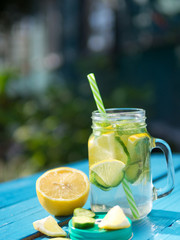 Dietary water. Lemonade with cucumber and mint on wooden table