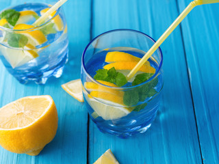 Refreshing lemonade with lemon and mint in glass glasses on the table