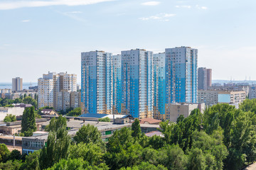 Fototapeta na wymiar Urban landscape from a height of 12 floors. Modern architecture, multi-storey residential buildings. City Of Saratov, Russia.