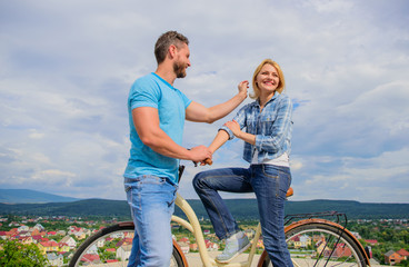 Obraz premium How to meet girls while riding bike. Man with beard and shy blonde lady on first date. Couple just meet to become acquainted. Woman feels shy in company with attractive macho. Picking up girl