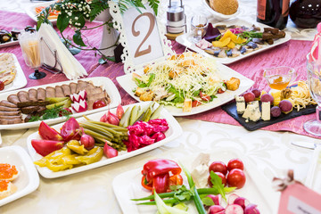 Served tables at the Banquet. Drinks, snacks, delicacies and flowers in the restaurant. A gala event or wedding.