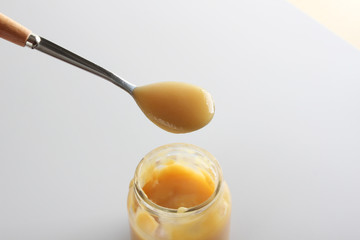 puree baby in a glass on a light background