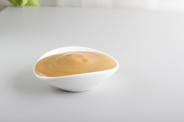 puree baby in a glass on a light background