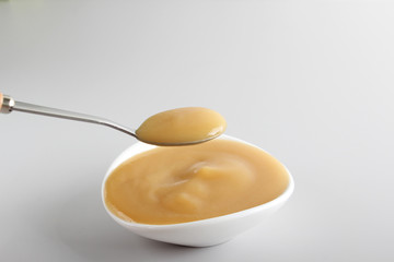 puree baby in a glass on a light background