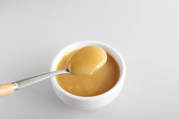 puree baby in a glass on a light background