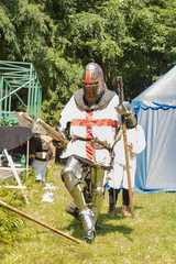 A participant of the festival in knight armor prepares for a duel