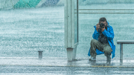 Photographer under heavy rain