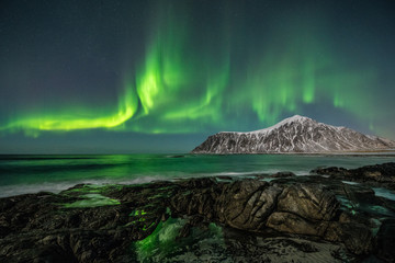 Fototapeta na wymiar Norway - Lofoten island - Skagsanden beach rocks with large Aurora