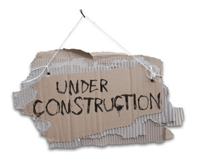 Under construction, Cardboard sign on a cord. 
Ripped, corrugated paper hanging on cord with white sign UNDER CONSTRUCTION. Usefull for web site under construction.Isolated on white background.