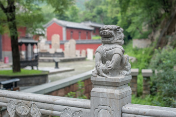 Fototapeta na wymiar Stone lion on bridge next to Lingyan Temple entrance. There are many of them in order to show 