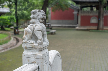 Fototapeta premium Stone lion on bridge next to Lingyan Temple entrance. There are many of them in order to show 