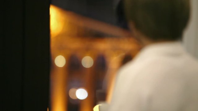 Young businessman after successful day drinks coffee in hotel room
