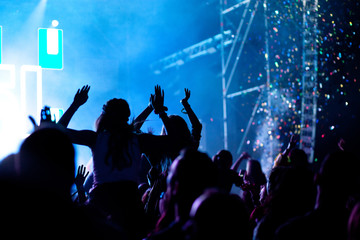 Fototapeta na wymiar cheering crowd with raised hands at concert - music festival