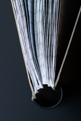 Closed notebook on a spring with white sheets in a cage