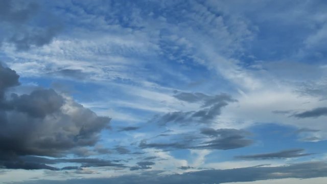 Beautiful cloudscape with large, building clouds and sunrise breaking through cloud mass.