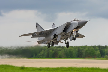 Air military bomber perfoming take off from the airbase runway in Russia. Air fighter flying around base. Aviation mission of military flight.