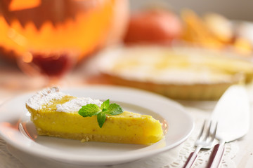 Pumpkin cake, cooked for the celebration of Halloween and decorated with mint twig. Food photography