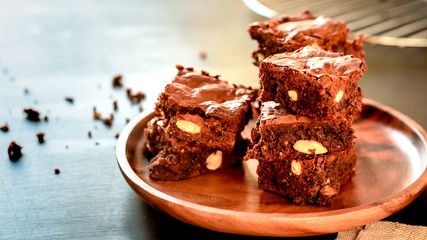 pyramid of freshly prepared home fresh brownies with nuts and figs, on a black background