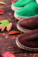 Brown and green man suede boots espadrilles on wooden