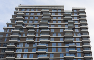 New or recently completed multi-storey residential building with windows and balconies.