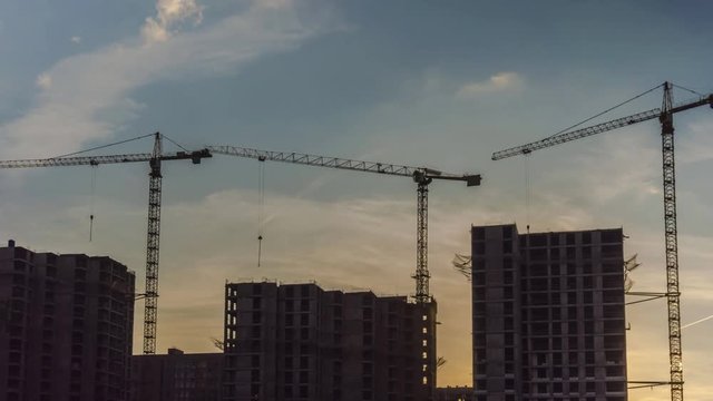 Cranes working day and night on construction of the housing estate in former industrial zone, time lapse