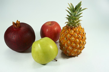 Still life with pineapple, apples and pomegranate