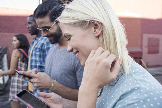 Young People Using Cell Phones Outdoors