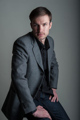 Portrait of a handsome businessman in a suit on a dark studio background.