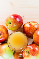 Glass of fresh apple cider near autumn apples