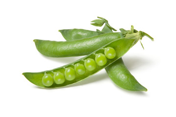 Green fresh opened peas isolated on white background