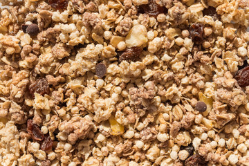 Muesli breakfast with oatmeal cereals raisins. Close up view of crunchy granola, muesli pile with banana slices and chocolate. Can be used as a background. Top view. Healthy eating. proper nutrition.