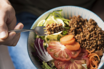young man eating a buddha bowl