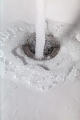 Water running. Waste of drinking water with the tap open