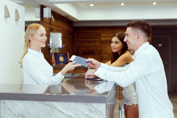 couple near reception desk in hotel