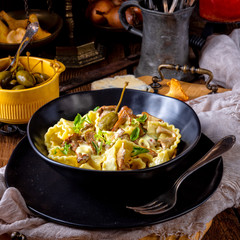 Reginette noodles in cream sauce with fresh chanterelles and capers