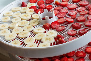 Fresh strawberry slices bananas prepared for drying in a dehydrator