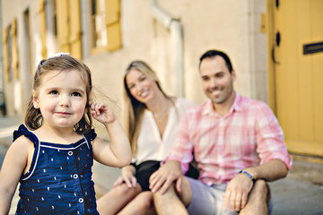 Parent and child girl having fun on old city street
